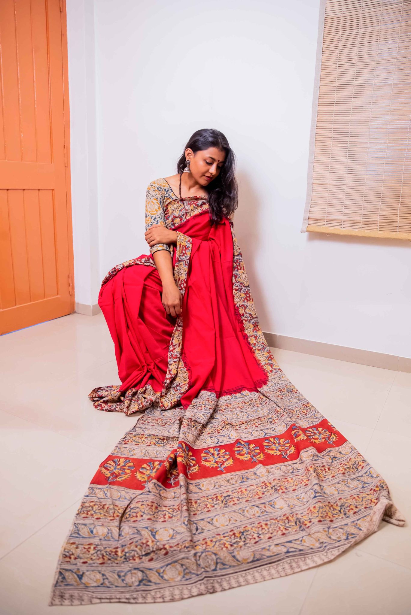 Red plain mul mul cotton saree with hand block printed kalamkari border and palla
